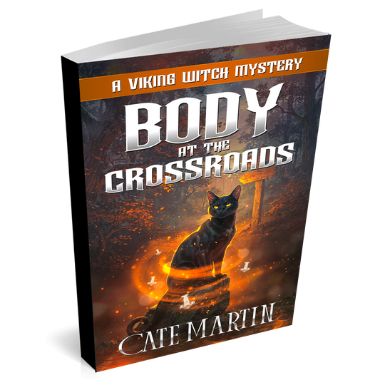 Book titled 'Body at the Crossroads' by Cate Martin with a black cat on the cover.