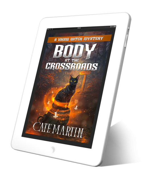 Tablet displaying the book cover 'Body at the Crossroads' by Cate Martin on a white background