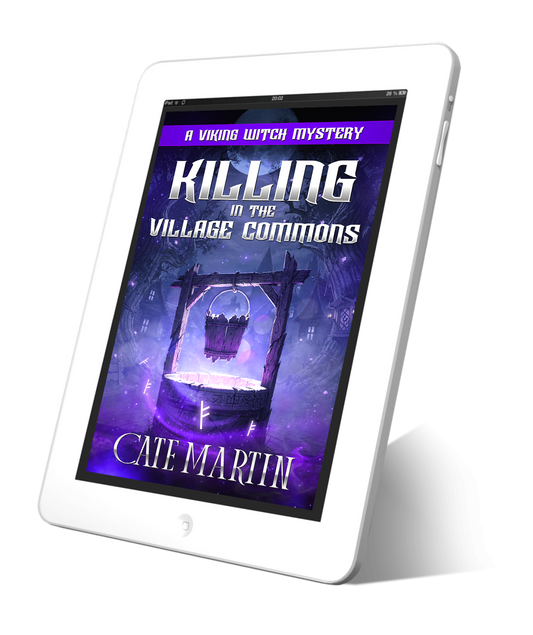 Tablet displaying the book cover of 'Killing in the Village Commons' by Cate Martin on a white background