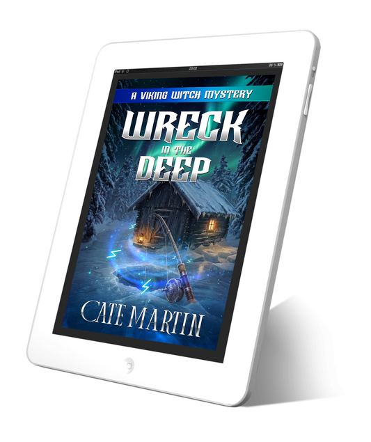 Image is of a cover for an ebook displayed on a tablet. The title is Wreck in the Deep A Viking Witch Mystery. The image is of a fishing house on a frozen lake surrounded by snow-covered pine trees. The Northern Lights are shining overhead and magical runes are dancing around a hole in the ice.